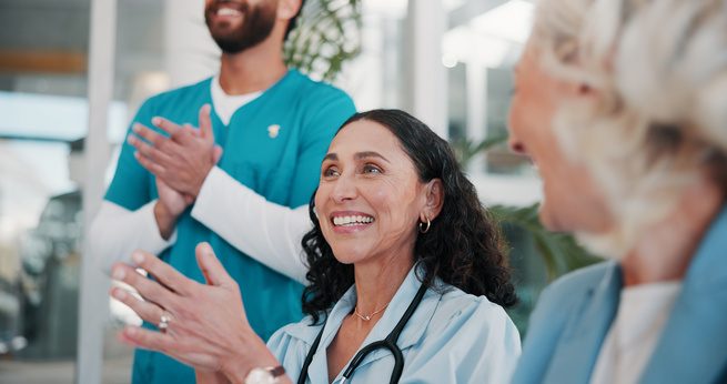 Nurse practitioner greeting a patient in a clinic exam room