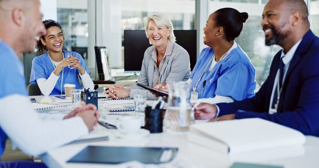 Healthcare recruiting team meeting with clinicians and administrators around a conference table