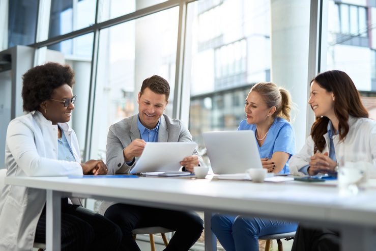Healthcare executive leadership team meeting at a conference table