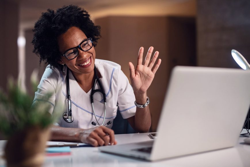 Physician connecting with a colleague by video call